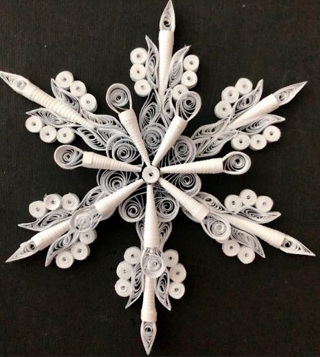 An Image showcasing a paper-quilled snowflake that is featured in the virtual product
